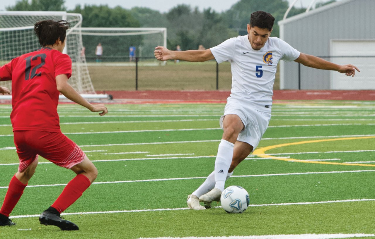 Alex Caballero works to move the ball past Southmont's Greiner.